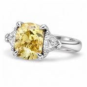 Angled View Of 1.82 Carat Fancy Yellow Cushion Cut Three Stone Diamond Ring