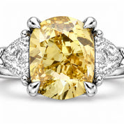 Close up View Of 1.82 Carat Fancy Yellow Cushion Cut Three Stone Diamond Ring