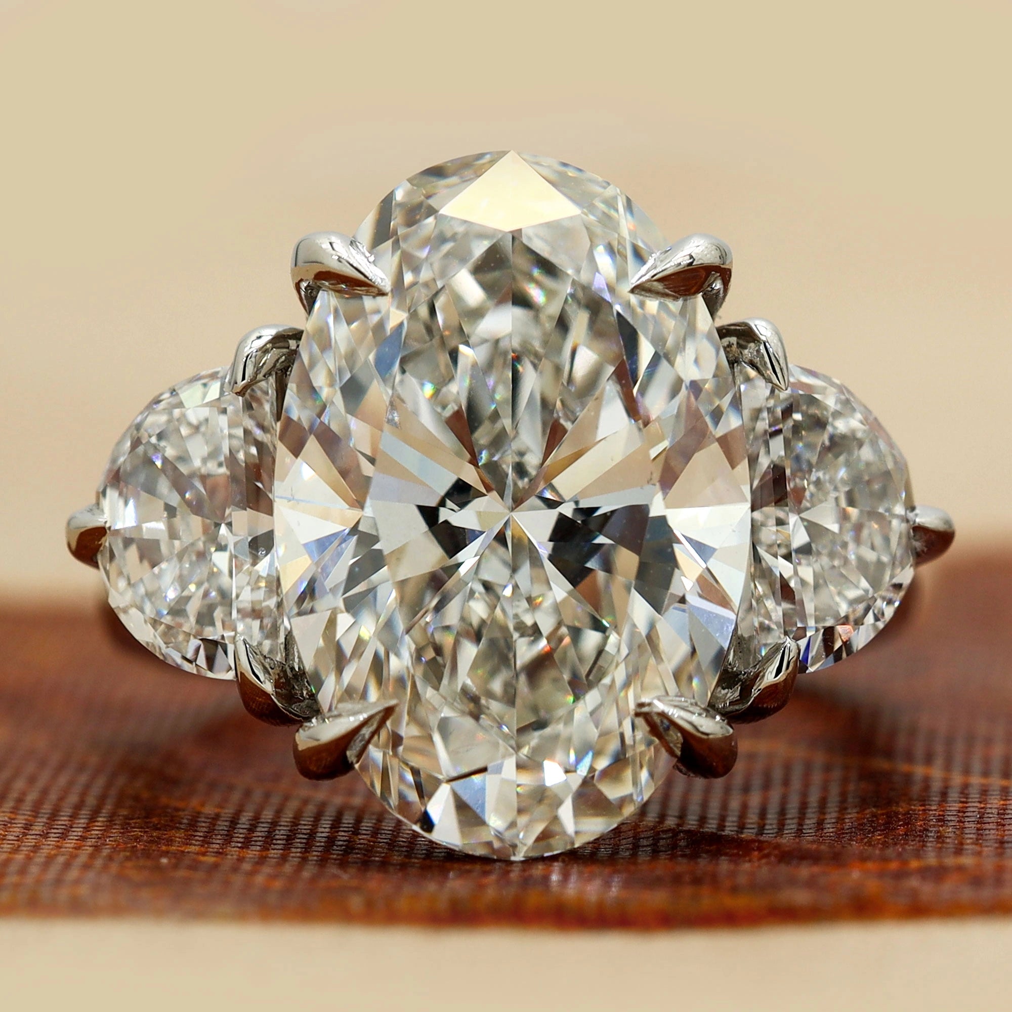 Front View of 8.9 Oval Cut diamond engagement ring paired with half-moon cut