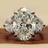 8.9 Oval Cut diamond engagement ring paired with half-moon cut