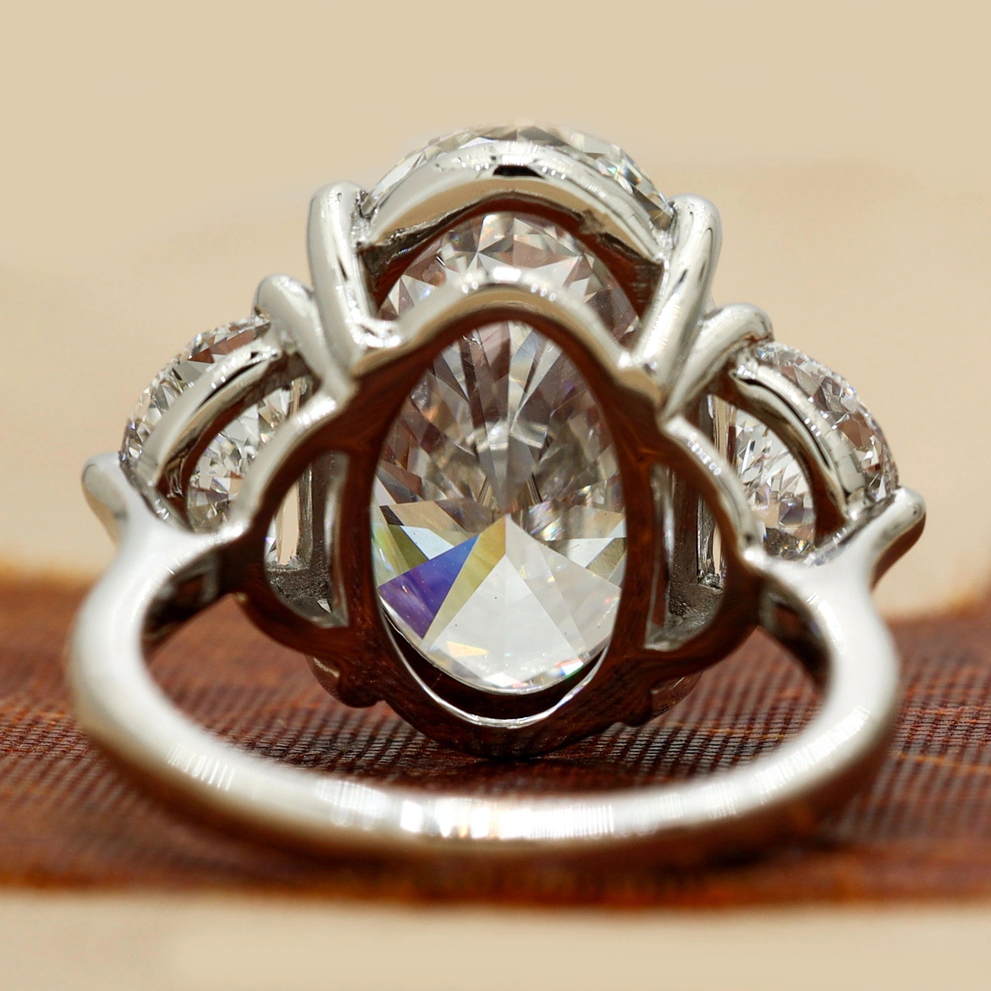 8.9 Oval Cut diamond engagement ring paired with half-moon cut