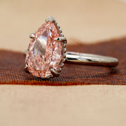 Angled view of 3 Carat Pink Pear Cut Diamond Solitaire Ring with Plain Band in Prong Setting