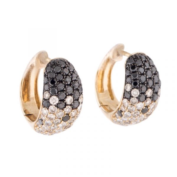 A pair of rose gold huggie earrings with a pave setting of white and black diamonds.